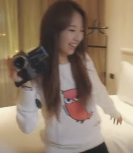 Haseul wearing a shirt with a red owl on it.